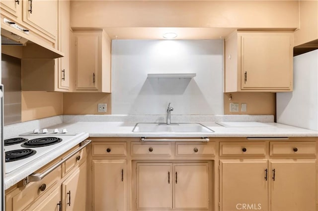 332 E 7th St, San Jacinto, CA 92583 - kitchen with white electric stovetop, sink, and cream cabinetry