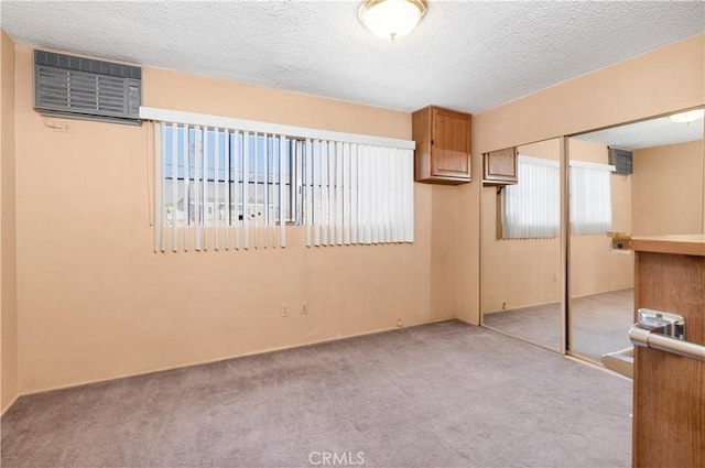 332 E 7th St, San Jacinto, CA 92583 - interior space with light carpet, a textured ceiling, and a wall mounted AC