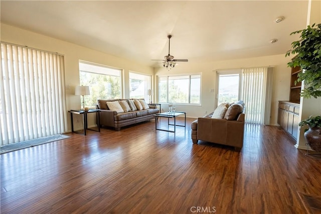 living room with ceiling fan, dark wood finished floors, and baseboards