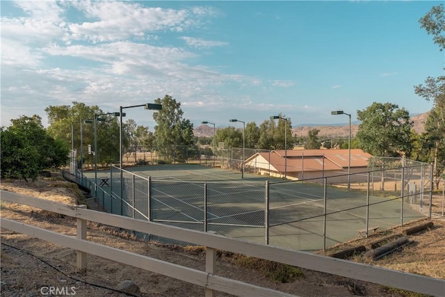 view of tennis court with fence