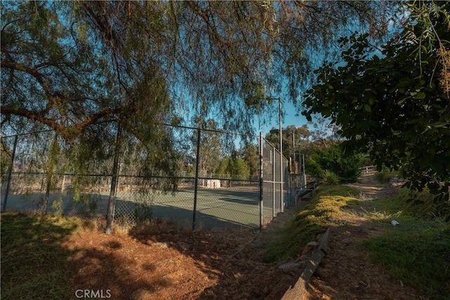 view of sport court with fence