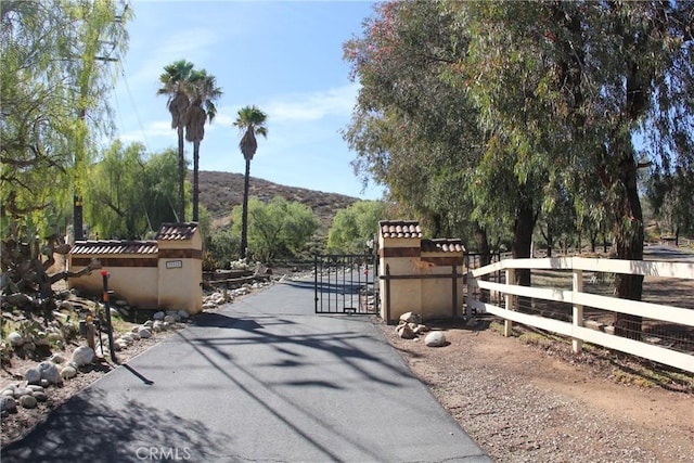 view of gate featuring fence and a mountain view