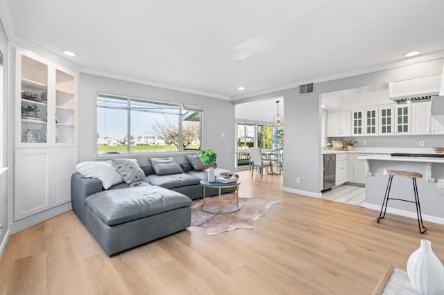 living room with ornamental molding and light hardwood / wood-style floors