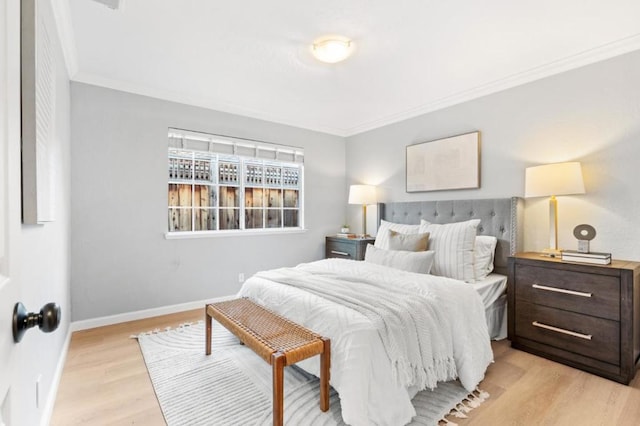 bedroom with ornamental molding and light wood-type flooring