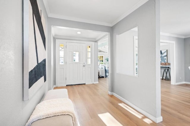 foyer featuring ornamental molding and light hardwood / wood-style floors