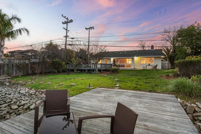 dock area with a wooden deck and a yard