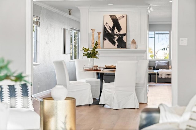 dining area with crown molding and hardwood / wood-style flooring