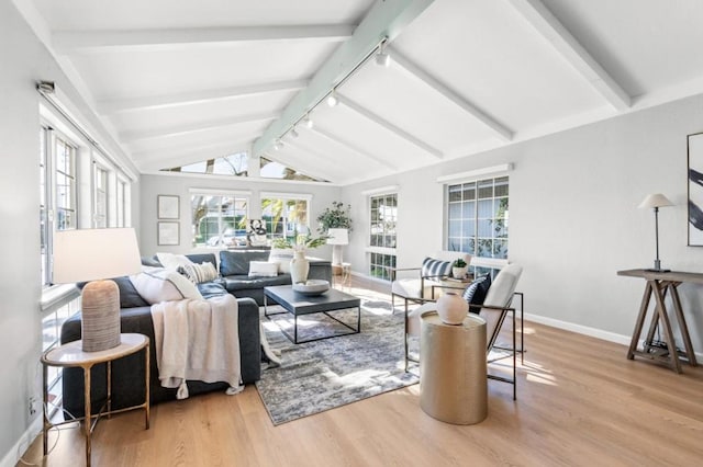 sunroom / solarium with rail lighting and lofted ceiling with beams