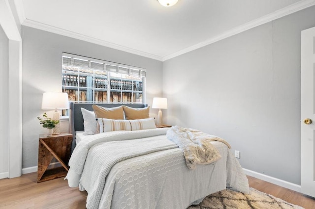 bedroom with crown molding and hardwood / wood-style flooring