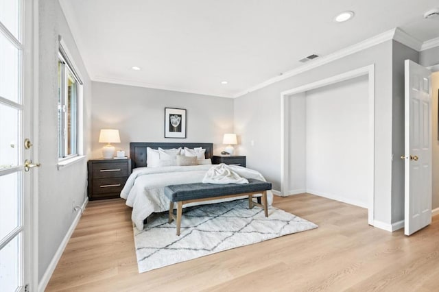 bedroom with crown molding and light wood-type flooring