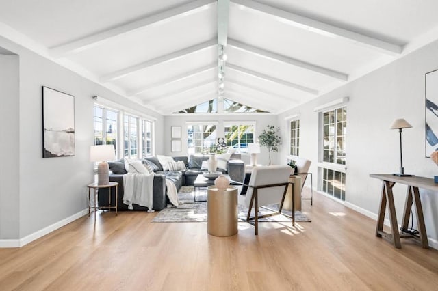 living room featuring vaulted ceiling with beams and light wood-type flooring