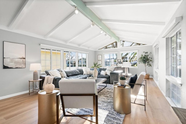 sunroom with track lighting and lofted ceiling with beams