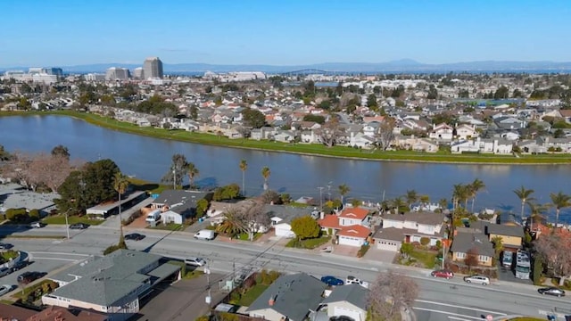 birds eye view of property with a water and mountain view