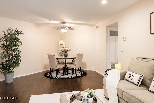 dining room with dark hardwood / wood-style flooring and ceiling fan