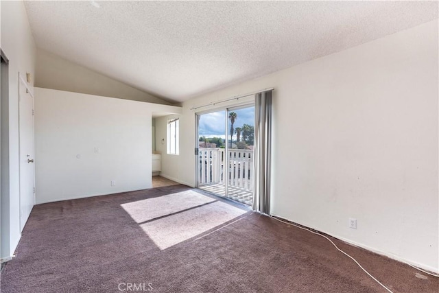 carpeted spare room with lofted ceiling and a textured ceiling