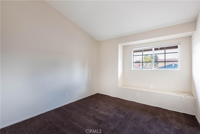 carpeted empty room with lofted ceiling