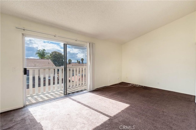 carpeted spare room with a textured ceiling