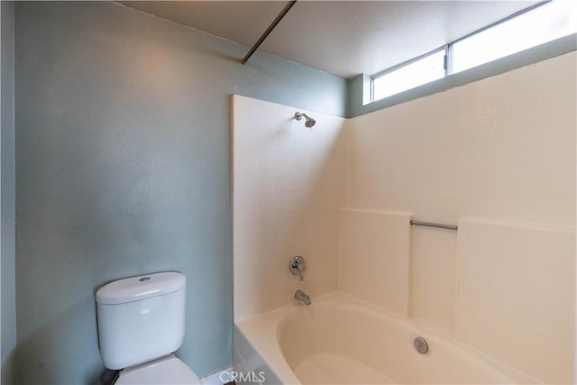 bathroom with toilet and  shower combination