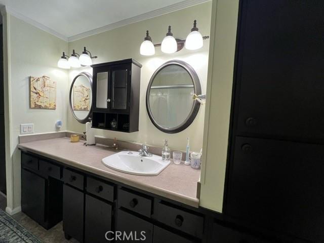 bathroom with ornamental molding and vanity