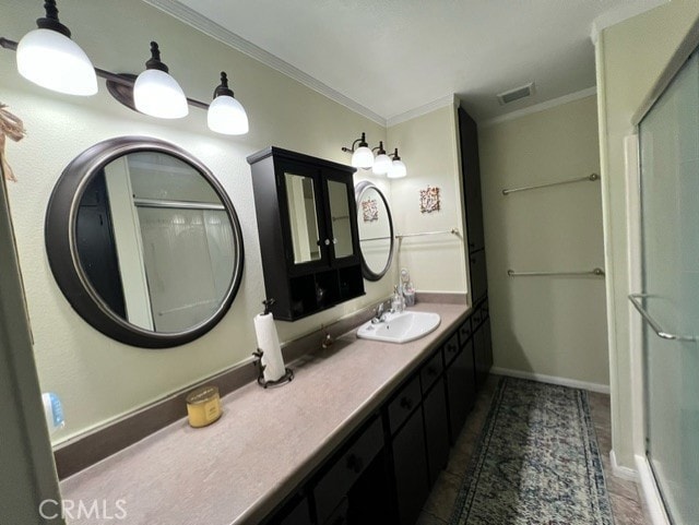 bathroom featuring crown molding, vanity, and a shower with shower door