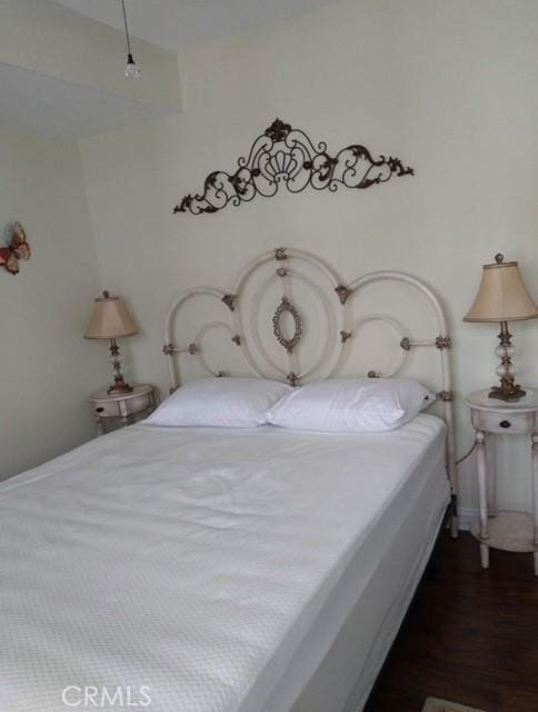 bedroom featuring dark hardwood / wood-style flooring