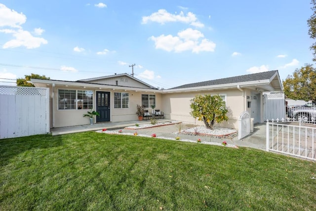 back of property with a yard and a patio area