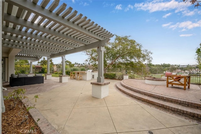 view of patio / terrace with an outdoor living space, a pergola, an outdoor bar, and exterior kitchen