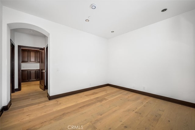 spare room featuring light hardwood / wood-style flooring