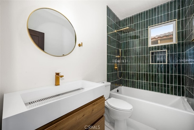 full bathroom featuring tiled shower / bath combo, vanity, and toilet