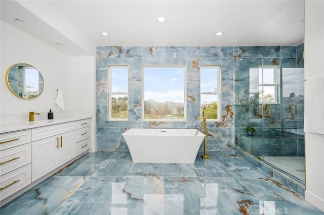 bathroom featuring vanity, plus walk in shower, and tile walls