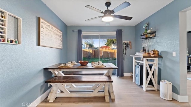 dining room featuring breakfast area, ceiling fan, and light hardwood / wood-style floors