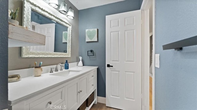 bathroom with hardwood / wood-style flooring and vanity