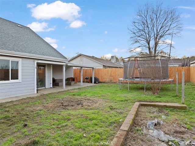 view of yard featuring a trampoline and a patio area