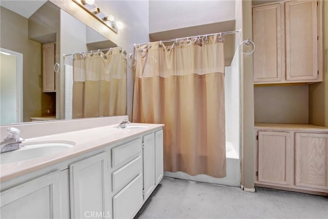 bathroom featuring double vanity, shower / bath combination with curtain, and a sink