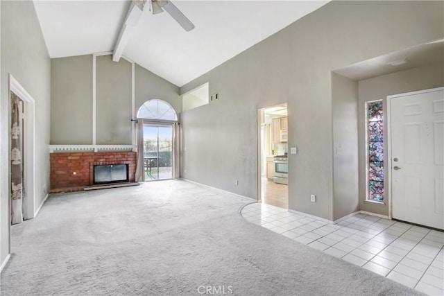 unfurnished living room with a fireplace, high vaulted ceiling, light colored carpet, ceiling fan, and beam ceiling