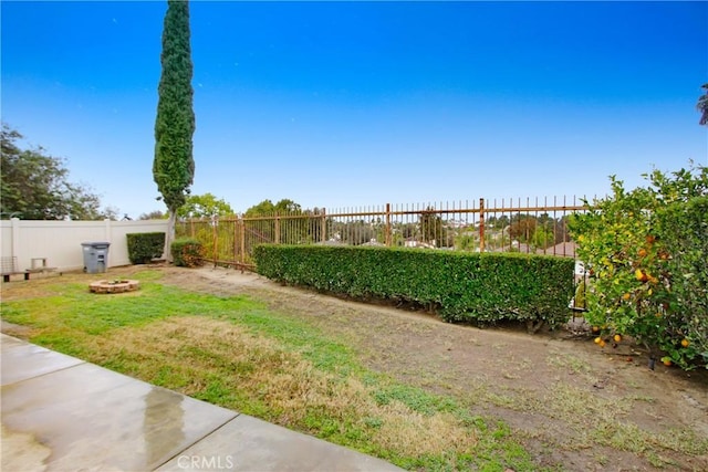 view of yard with a fire pit and fence private yard