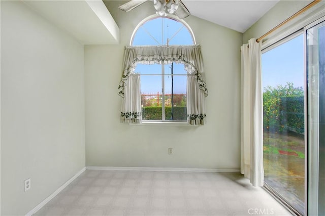 unfurnished room with lofted ceiling, ceiling fan, baseboards, and tile patterned floors