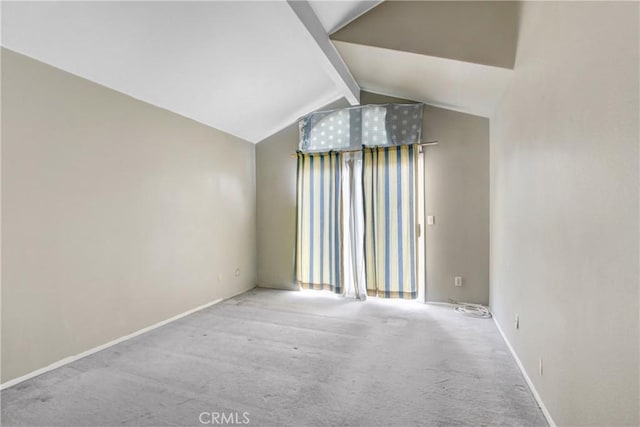 spare room featuring lofted ceiling with beams and carpet floors