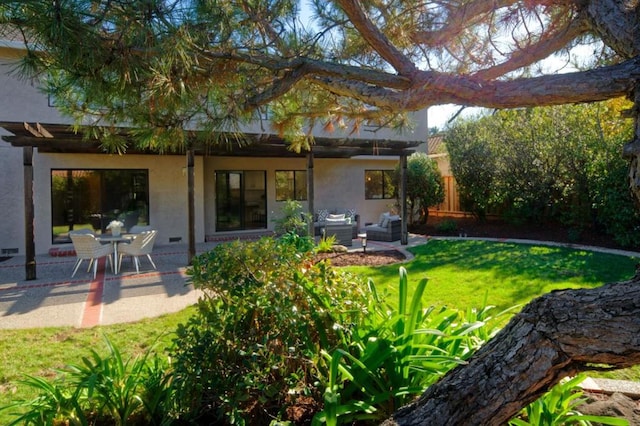 back of house with a yard, outdoor lounge area, and a patio