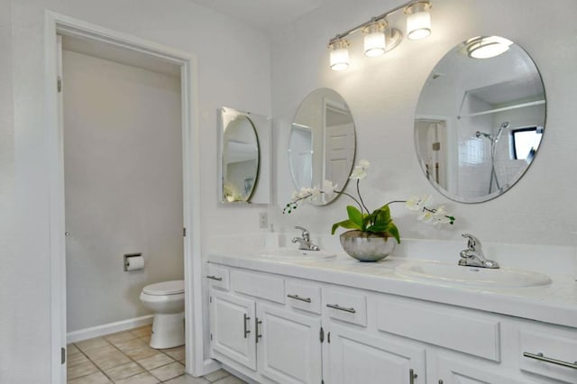 bathroom with vanity, walk in shower, tile patterned floors, and toilet