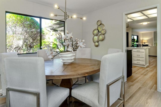 dining space featuring a chandelier and light wood-type flooring