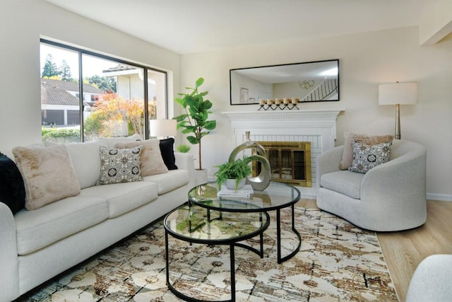 living room featuring a fireplace and light wood-type flooring