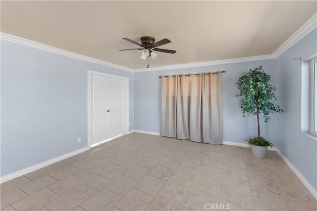 spare room with ornamental molding and ceiling fan