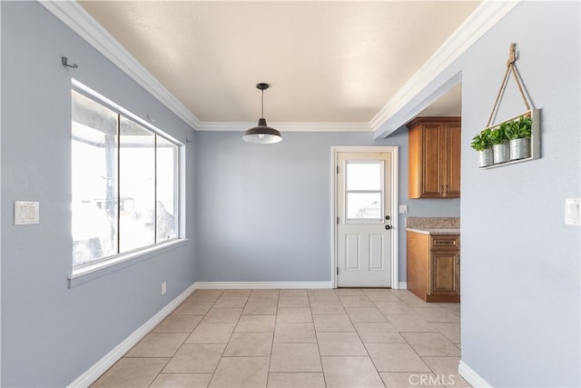 unfurnished dining area with ornamental molding and light tile patterned floors