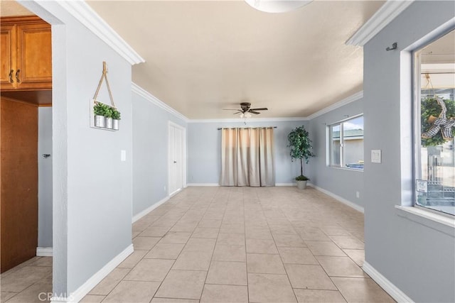 spare room featuring crown molding, ceiling fan, and light tile patterned flooring