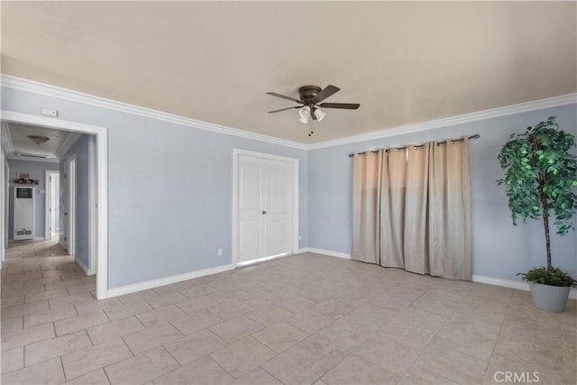 tiled empty room with crown molding and ceiling fan