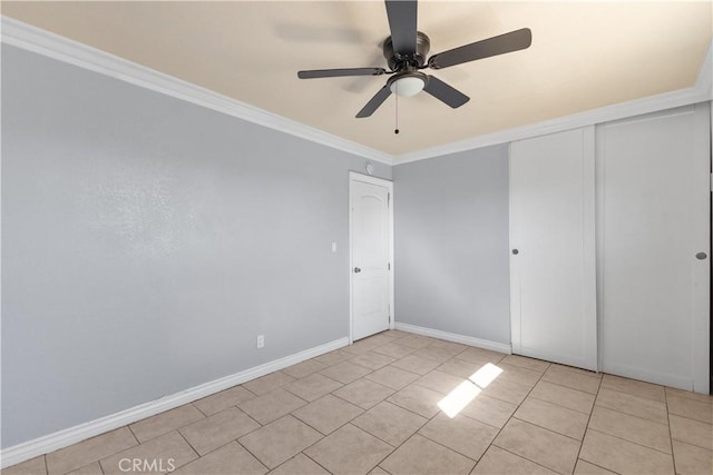 unfurnished bedroom featuring light tile patterned floors, crown molding, a closet, and ceiling fan