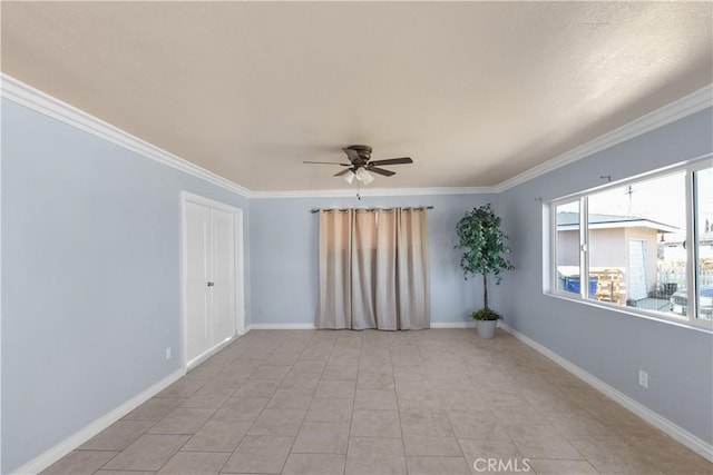 tiled empty room featuring crown molding and ceiling fan