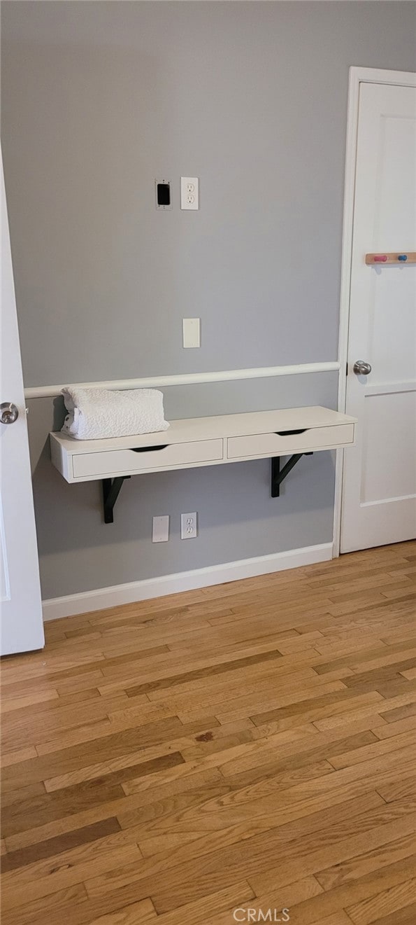 interior space with light wood-style floors and baseboards