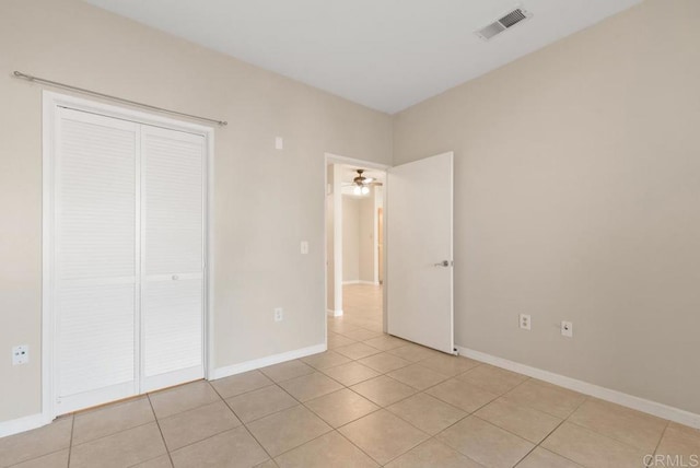 unfurnished bedroom with light tile patterned floors and a closet